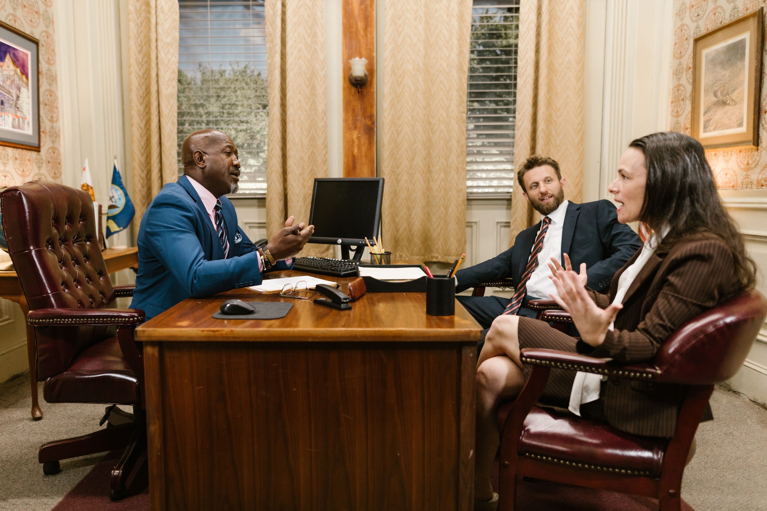 Three attorneys discussing legal work in a professional law office