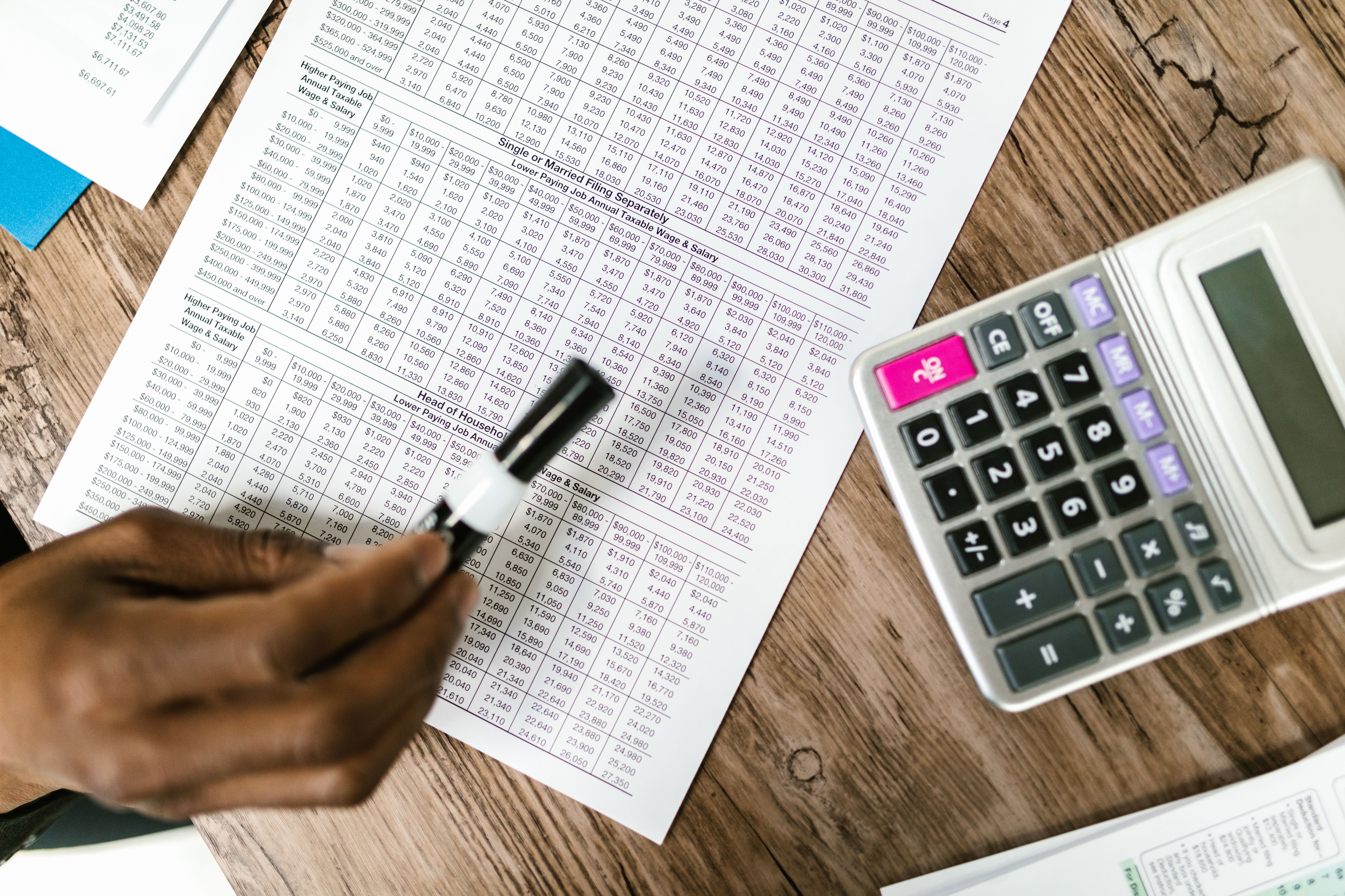Calculator and financial documents representing law firm expense analysis