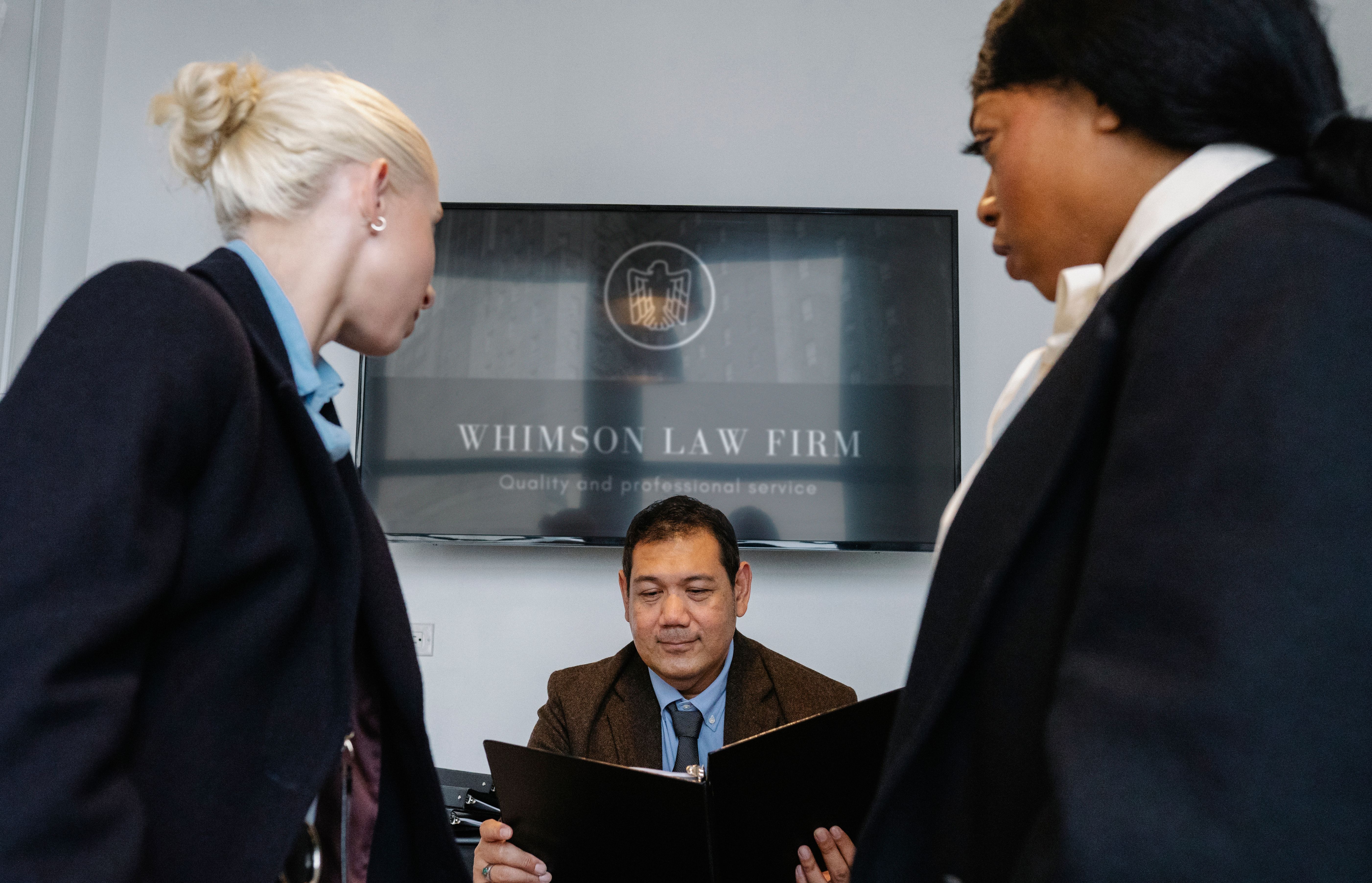 Law firm colleagues reviewing a contract together in a conference room